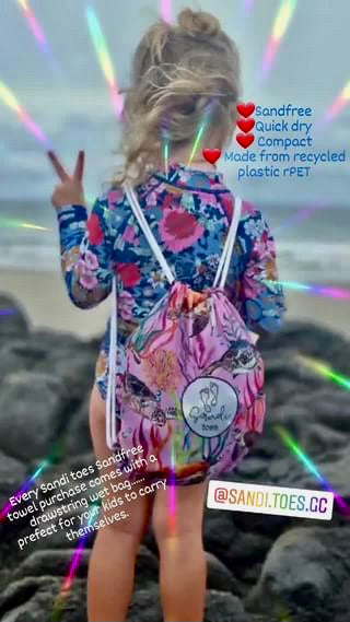 Young Child with Turtle Cove Hooded Beach towel going to the beach with her Turtle Cove towel in her back pack which is included