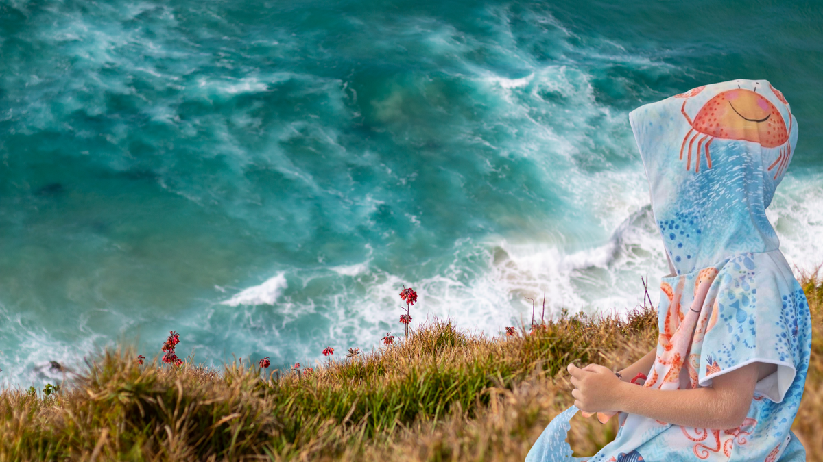 Under the Sea sand free towel a boy sits on a hilltop contemplating the fun day he has had and what the future may hold