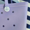 Coral Cove Silicone Bag with Sandi Toes Logo: Everyday Essentials in Style. [Durable coral cove purple silicone bag displays the Sandi Toes logo, ideal for carrying your essentials with a touch of beach flair.]