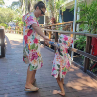 Matching Island Princess Sand-Free Hoodies (One Size Fits All): Mother and Daughter Enjoying the Boardwalk. Towering trees line the tropical beach setting.