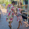 Mum and daughter share a laugh at Hastings Point Caravan Park. They are both wearing Island Princess hooded beach hoodies featuring a vibrant design with hibiscus flowers.