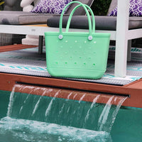 Sea Foam Silicone Bag sitting on top of swimming pool waterfall